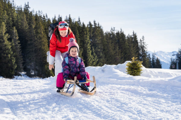 Family enjoying sledge in Tirol